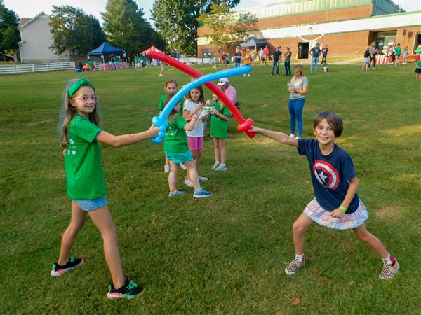 Students outside enjoying a family fun night for their school.